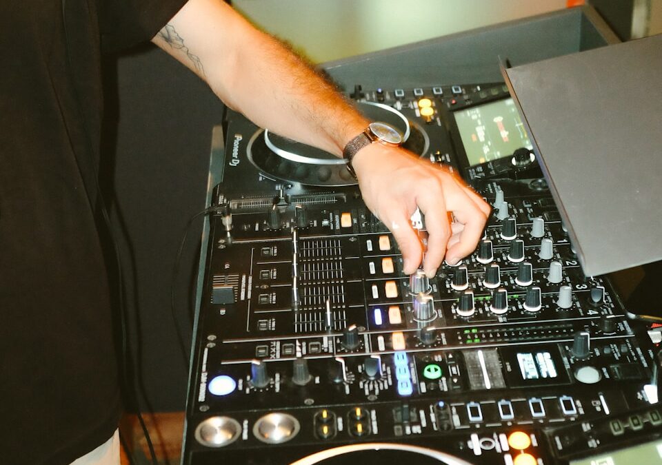 person in black t-shirt playing dj mixer