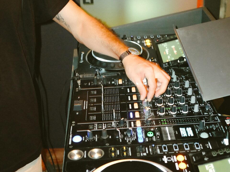 person in black t-shirt playing dj mixer