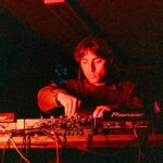 woman in black long sleeve shirt playing audio mixer