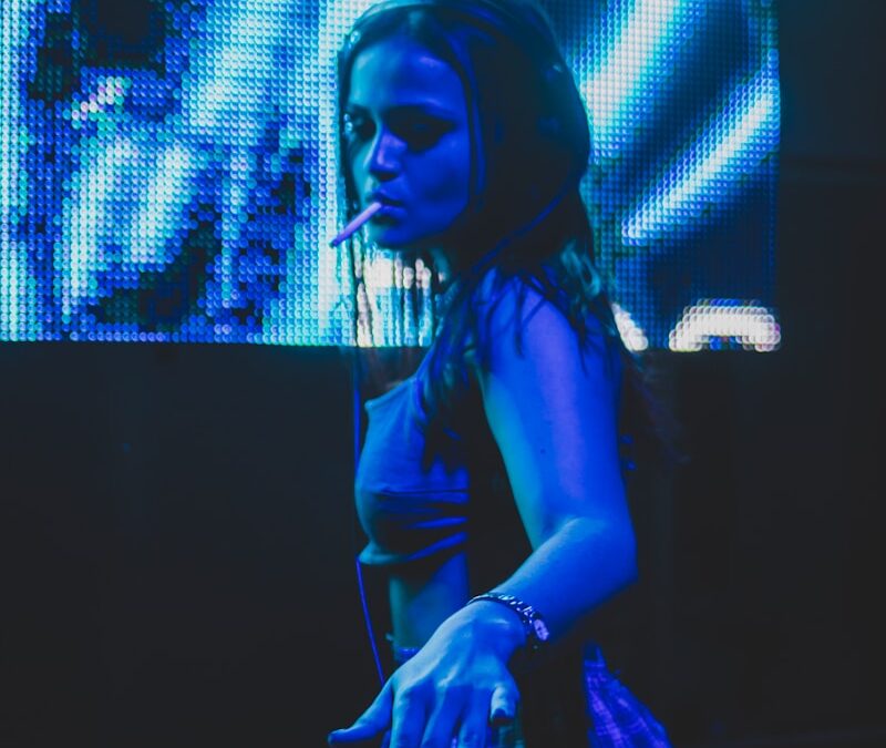 a woman that is standing in front of a dj mixer