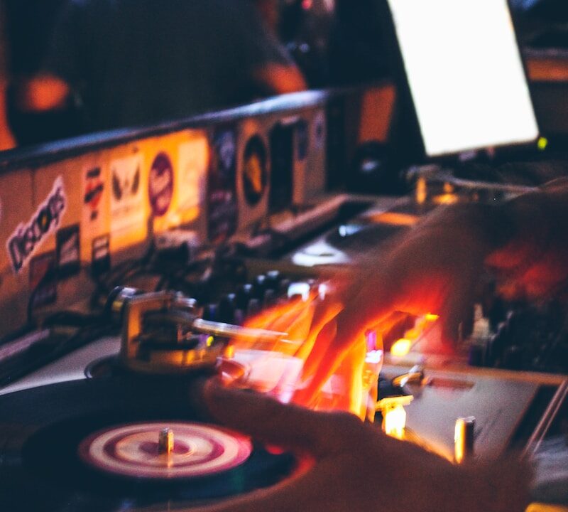 person holding black and grey DJ turntable